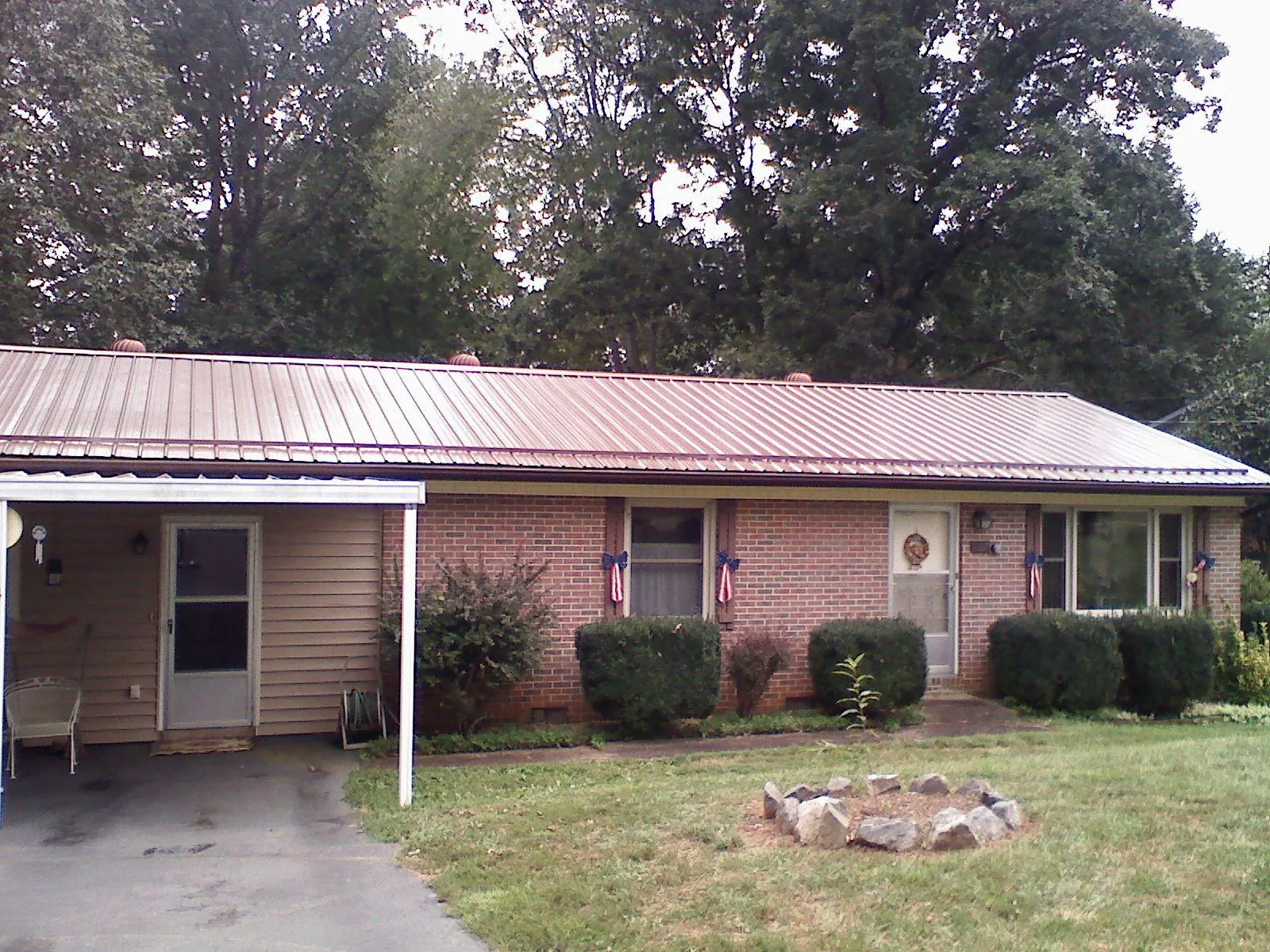 Bronze metal roof and carport on a brick ranch home — Roof Repair work by our crew in Sonoma